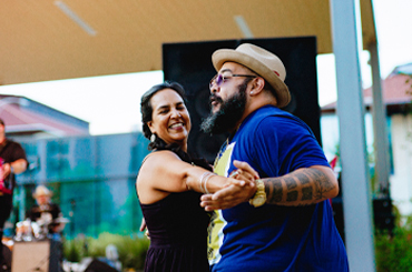 a couple dancing under the Capitol Mall Amphitheater.