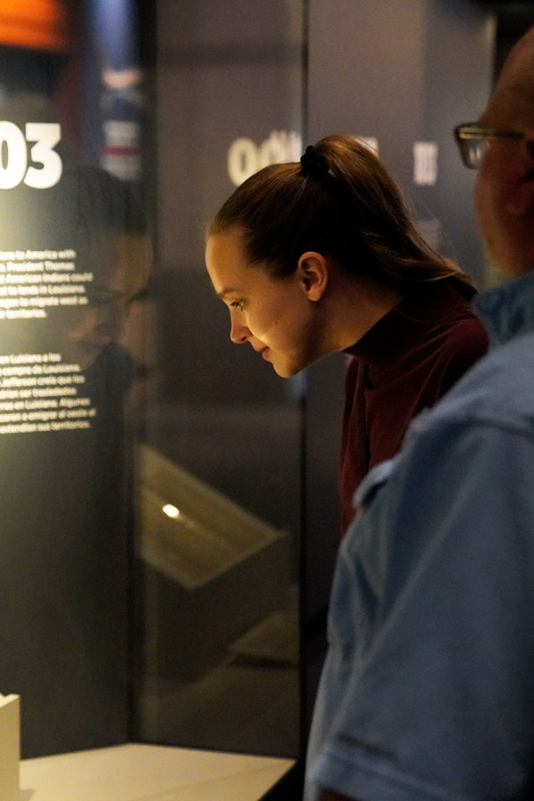 woman looking at an exhibit at the Bullock Museum