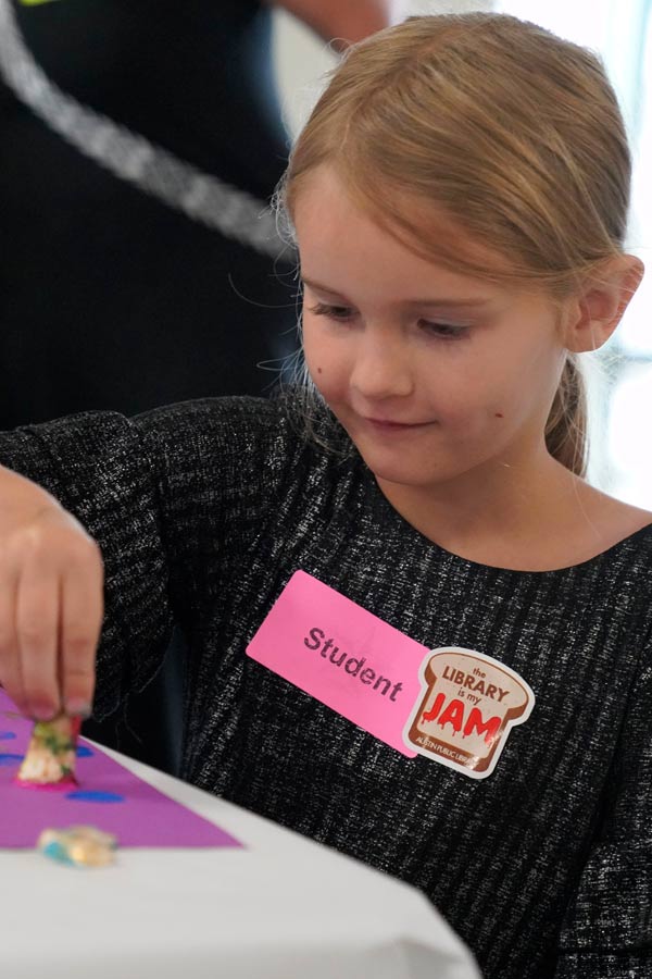 a young girl doing a craft activity at the Bullock Museum