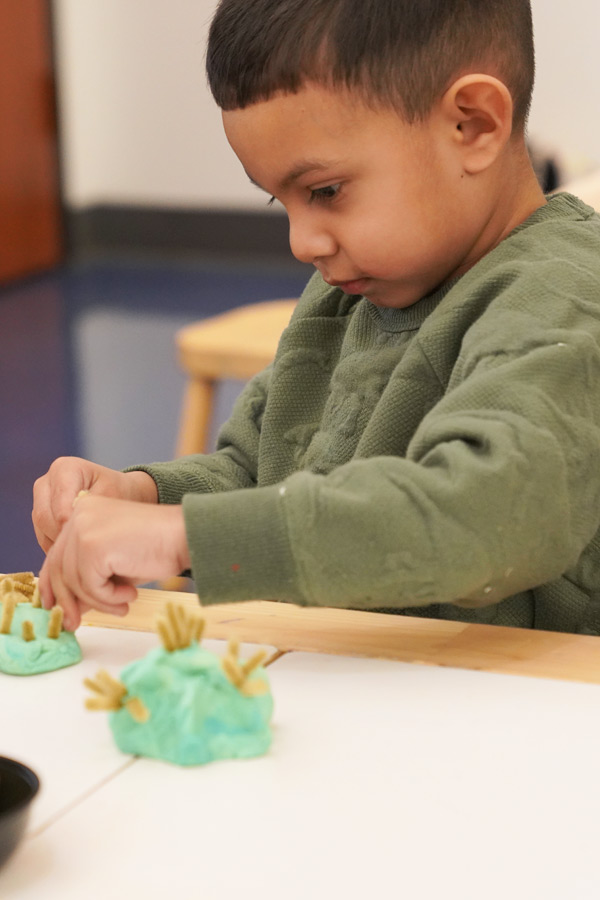 a young child doing a craft at the Bullock Museum