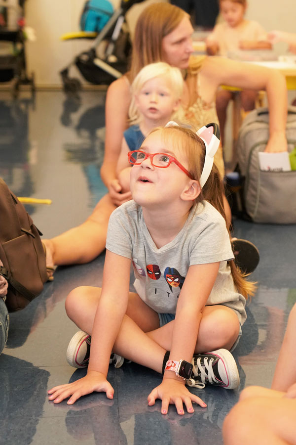 a young girl smiling at an instructor during an activity at the Bullock Museum
