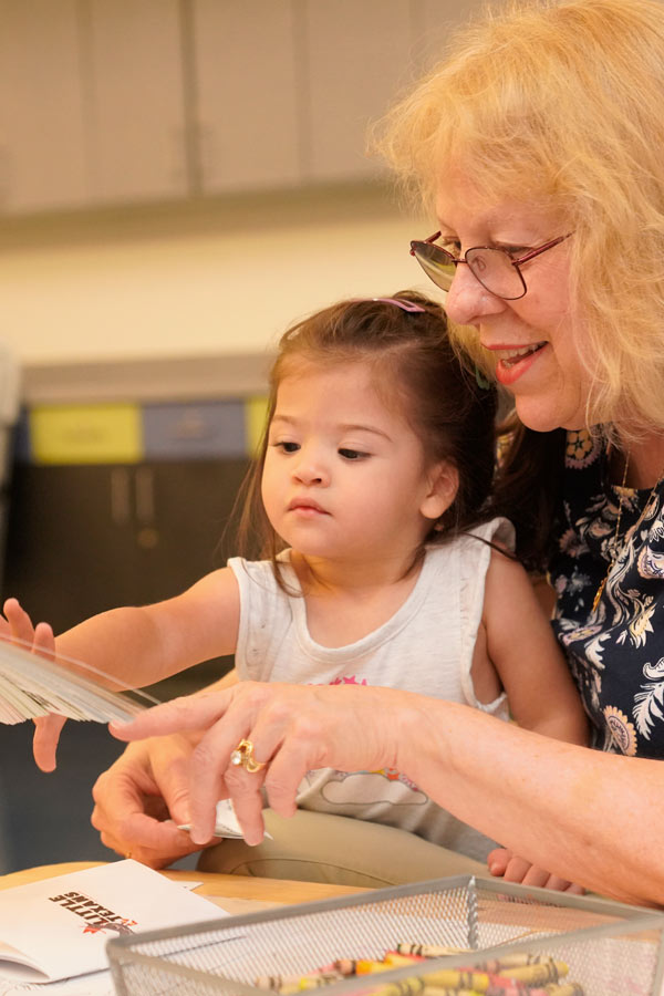 a young girl and her caregiver doing a craft activity at the Bullock Museum