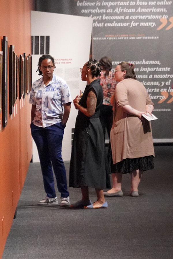 a group of people looking at a Museum exhibit