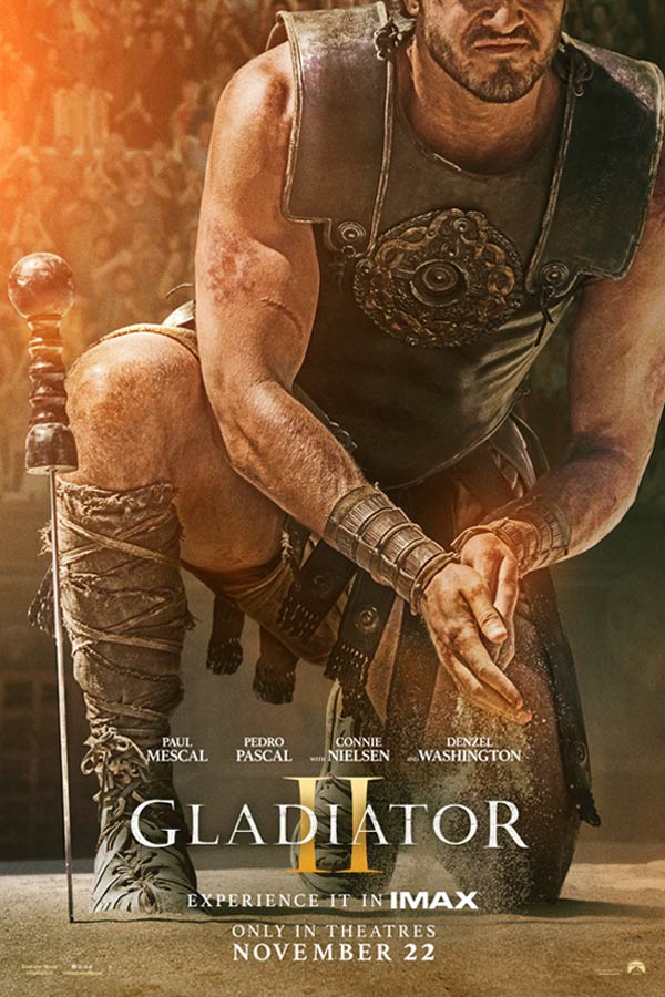 film poster for "Gladiator II" with Paul Mescal dressed as a gladiator rubbing dirt in his hands