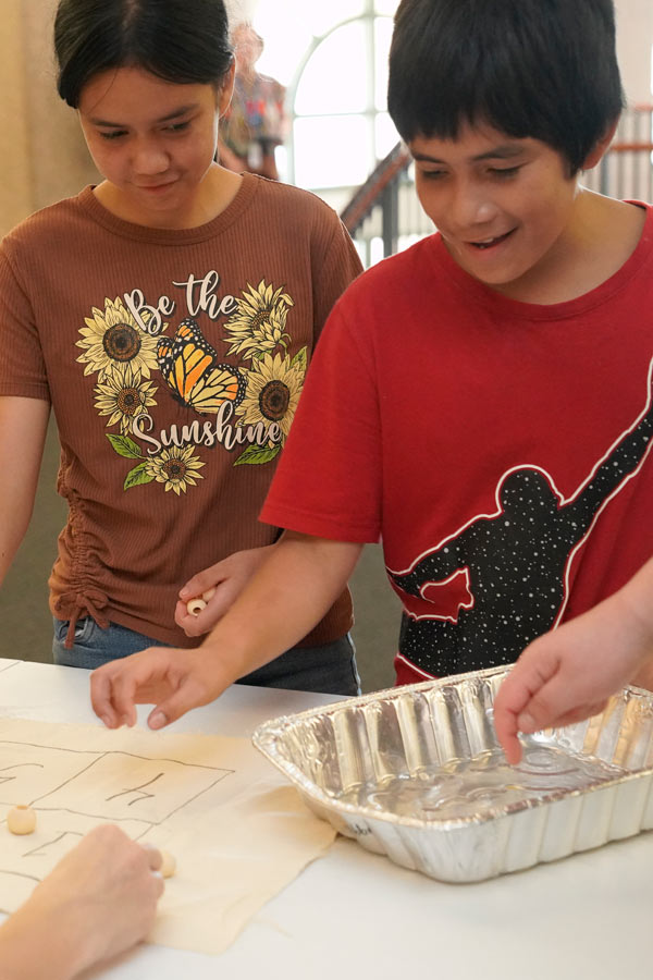 two children doing a STEAM craft at the Bullock Museum