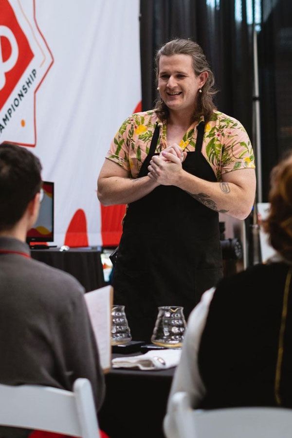 a person wearing an apron facilitating a coffee tasting 