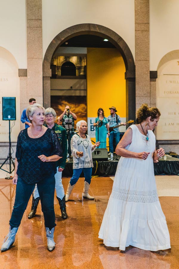 people dancing in the lobby of the Bullock Museum