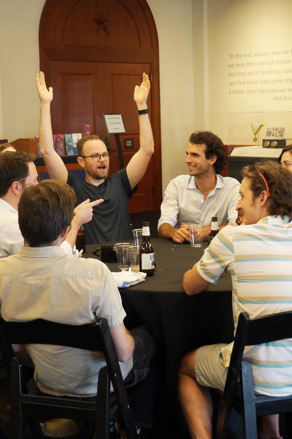 a table full of trivia players celebrating a win at the Bullock Museum