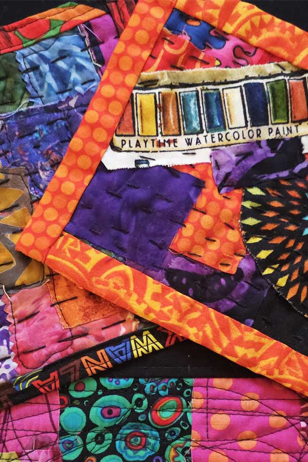 a quilt with patches of colorful fabric