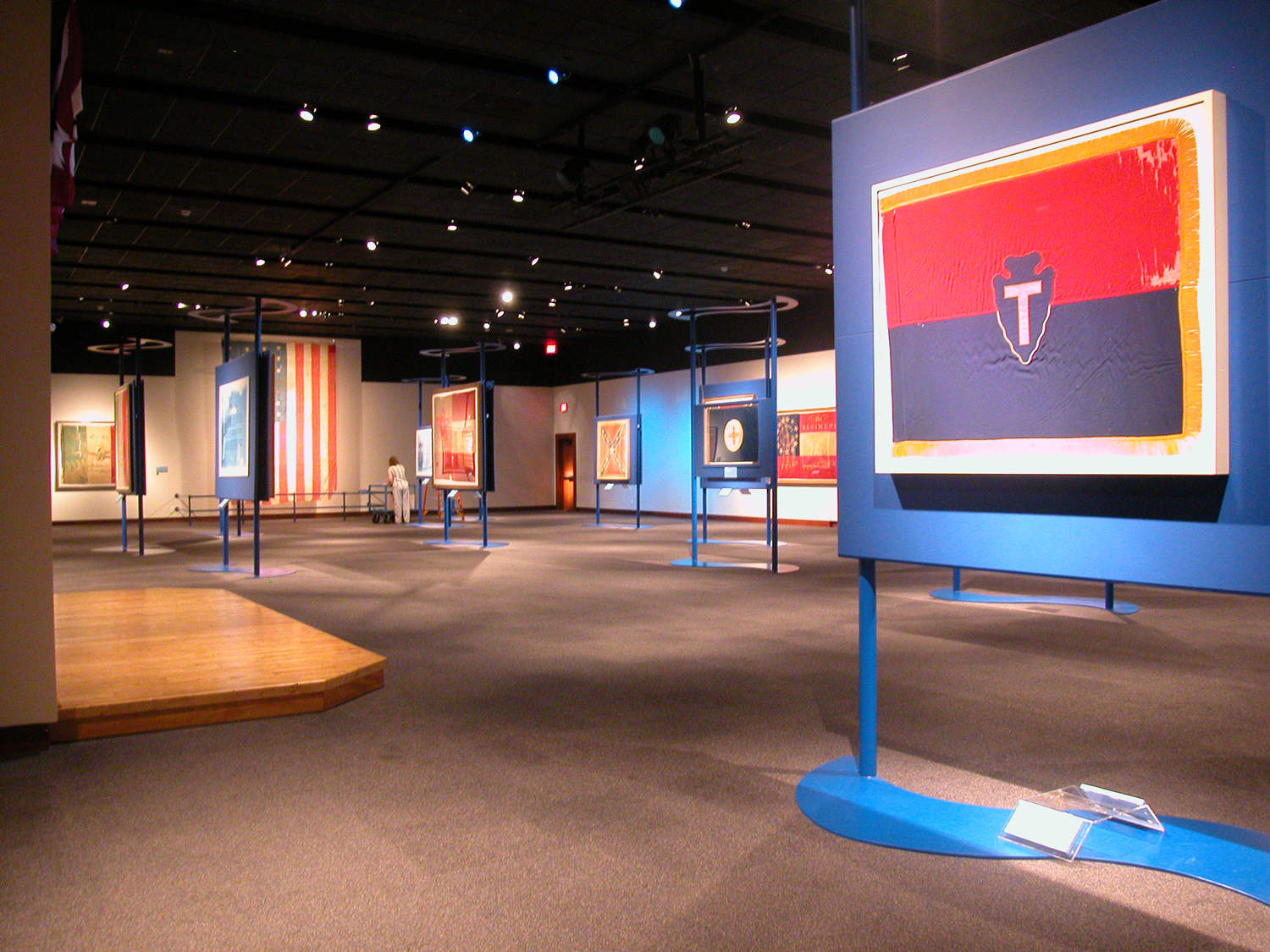 museum hall showing exhibit of various Texas flags