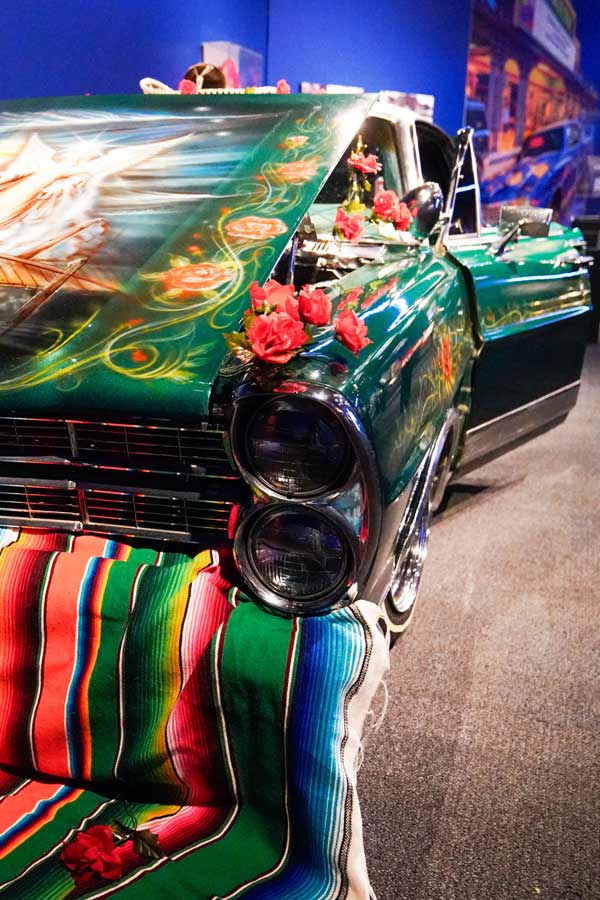 a green 1967 Ford LTD lowrider on display at the Bullock Museum