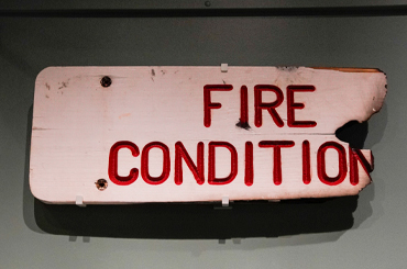 A partially burned sign that reads, Fire Condition"