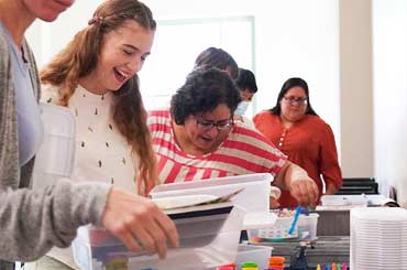 educators looking at activity worksheets at an event